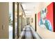 Hallway with art, modern lighting, and access to outdoor pool and patio areas at 66 Golf Estates Dr, Las Vegas, NV 89141