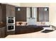 Sleek modern kitchen with stainless steel appliances and dark wood custom cabinets at 66 Golf Estates Dr, Las Vegas, NV 89141