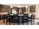 Modern eat-in kitchen with stainless steel appliances, custom cabinetry, and island seating at 66 Golf Estates Dr, Las Vegas, NV 89141