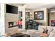Inviting living room with stone fireplace, adjacent wet bar, and comfortable seating area at 66 Golf Estates Dr, Las Vegas, NV 89141