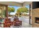 Elegant living room with stone fireplace and sliding doors to a tranquil outdoor patio at 66 Golf Estates Dr, Las Vegas, NV 89141