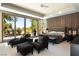 Spacious main bedroom with sitting area and expansive windows overlooking lush landscaping at 66 Golf Estates Dr, Las Vegas, NV 89141