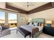 A relaxing bedroom with a large window, balcony, a patterned chair, and sleek, modern furniture at 66 Golf Estates Dr, Las Vegas, NV 89141