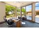 Bright office space with large windows overlooking the pool and backyard, promoting a serene work environment at 66 Golf Estates Dr, Las Vegas, NV 89141