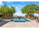 Enjoy this backyard rectangular pool and lush landscape with desert and mountain views at 66 Golf Estates Dr, Las Vegas, NV 89141