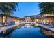 Luxury home showcasing a pristine pool with a spa, surrounded by lounge chairs and architectural details at 66 Golf Estates Dr, Las Vegas, NV 89141