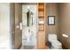 A modern powder room featuring a unique pedestal sink, stylish lighting, and neutral wall color at 66 Golf Estates Dr, Las Vegas, NV 89141