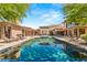 Stunning backyard oasis featuring a large swimming pool, ample lounging space, and picturesque mountain views at 66 Golf Estates Dr, Las Vegas, NV 89141