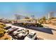 Condominium exterior with parking and view of the city skyline under a clear, blue sky at 737 Oakmont Ave # 1202, Las Vegas, NV 89109