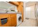 Galley kitchen with stainless appliances, granite counters, and adjacent utility closet at 737 Oakmont Ave # 1202, Las Vegas, NV 89109