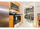 Kitchen featuring stainless steel oven and view into a bedroom with a built-in bookshelf at 737 Oakmont Ave # 1202, Las Vegas, NV 89109