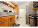 Efficient kitchen with modern appliances, wood cabinets, and adjacent laundry area at 737 Oakmont Ave # 1202, Las Vegas, NV 89109