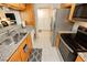 Kitchen with stainless steel appliances, light wood cabinets, and neutral granite countertops at 737 Oakmont Ave # 1202, Las Vegas, NV 89109