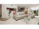 Comfortable living room with a gray sectional couch, glass table and balcony at 737 Oakmont Ave # 1202, Las Vegas, NV 89109
