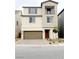 Modern two-story home featuring a balcony, a two-car garage, and low-maintenance landscaping at 7482 Lodano Ave, Las Vegas, NV 89113