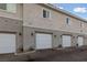 Row of well-maintained attached garages on a residential building, each with its own driveway access at 7544 Nicklin St, Las Vegas, NV 89143