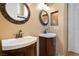 Dual sink vanity with dark wood cabinets, framed mirrors and tiled floor at 7685 Gilespie St, Las Vegas, NV 89123