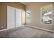 Neutral bedroom featuring carpeted floor and two windows providing natural light at 7685 Gilespie St, Las Vegas, NV 89123