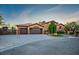Charming single-story home with a well-manicured lawn, mature trees, and a two-car garage at 7685 Gilespie St, Las Vegas, NV 89123