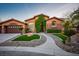 Front exterior showcasing stone accents, desert landscaping, and large driveway at 7685 Gilespie St, Las Vegas, NV 89123