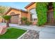 Beautiful exterior view highlighting landscaping, stone accents, and an inviting entrance at 7685 Gilespie St, Las Vegas, NV 89123