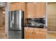 Open kitchen layout featuring stainless steel refrigerator and custom cabinets at 7685 Gilespie St, Las Vegas, NV 89123