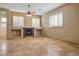 Spacious living room with travertine flooring and a cozy fireplace at 7685 Gilespie St, Las Vegas, NV 89123