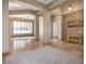 Open-concept living room with travertine floors, pillars, and ample natural light at 7685 Gilespie St, Las Vegas, NV 89123