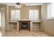 Open living room with tiled floors and a fireplace with recessed lighting at 7685 Gilespie St, Las Vegas, NV 89123