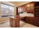 Office room features a large built-in desk, cabinets, drawers and a large window at 7685 Gilespie St, Las Vegas, NV 89123