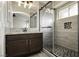 Modern bathroom featuring a granite countertop vanity, sliding glass shower, and stylish tile work at 7833 Mission Point Ln, Las Vegas, NV 89149