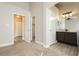 Bright bedroom showcasing neutral walls, plush carpet, and an en-suite bathroom with granite counters at 7833 Mission Point Ln, Las Vegas, NV 89149