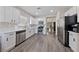 Modern kitchen with white cabinets, stainless steel appliances, and long sightlines at 7945 Grey Teal St, North Las Vegas, NV 89084