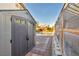 View of the backyard featuring a storage shed, patio area, greenhouse, and swimming pool at 8406 Belmont Valley St, Las Vegas, NV 89123