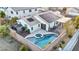 Aerial view of backyard featuring a pool, hot tub, shed, covered patio, and desert landscaping at 8406 Belmont Valley St, Las Vegas, NV 89123