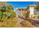 Landscaped backyard with gated access showcasing desert plants and a covered patio at 8406 Belmont Valley St, Las Vegas, NV 89123