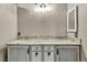 This bathroom features a double sink with a granite countertop and modern lighting at 8406 Belmont Valley St, Las Vegas, NV 89123