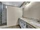 This bathroom is equipped with double sinks, a granite countertop and a glass shower at 8406 Belmont Valley St, Las Vegas, NV 89123