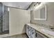 Bathroom showcasing double vanity with granite counters and a stone tile shower at 8406 Belmont Valley St, Las Vegas, NV 89123