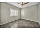 A bedroom featuring tiled floors, shuttered window, and ceiling fan at 8406 Belmont Valley St, Las Vegas, NV 89123