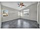 Spacious bedroom featuring tile floors, ceiling fan, and natural light from multiple windows at 8406 Belmont Valley St, Las Vegas, NV 89123