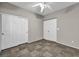 A neutral bedroom features a ceiling fan and a closet with sliding doors at 8406 Belmont Valley St, Las Vegas, NV 89123