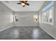 Bright bedroom featuring tile flooring, ceiling fan, and ample natural light from large windows at 8406 Belmont Valley St, Las Vegas, NV 89123