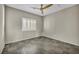 Bedroom showcasing shuttered window, ceiling fan, and durable tiled flooring at 8406 Belmont Valley St, Las Vegas, NV 89123