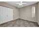 A light-filled room featuring tiled floors, a ceiling fan, and double door closet at 8406 Belmont Valley St, Las Vegas, NV 89123