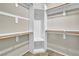 A closet is equipped with wood bars and white shelves for organization and storage at 8406 Belmont Valley St, Las Vegas, NV 89123