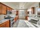 Modern kitchen with granite counters, stainless steel appliances, and rich wood cabinetry at 8406 Belmont Valley St, Las Vegas, NV 89123