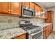 Close-up of kitchen showcasing granite countertops and stainless steel appliances at 8406 Belmont Valley St, Las Vegas, NV 89123