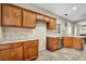 Traditional kitchen with granite counters, tile backsplash, stainless appliances, and warm wood cabinetry at 8406 Belmont Valley St, Las Vegas, NV 89123