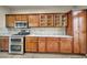 Well-equipped kitchen with stainless steel appliances and classic wood cabinets at 8406 Belmont Valley St, Las Vegas, NV 89123